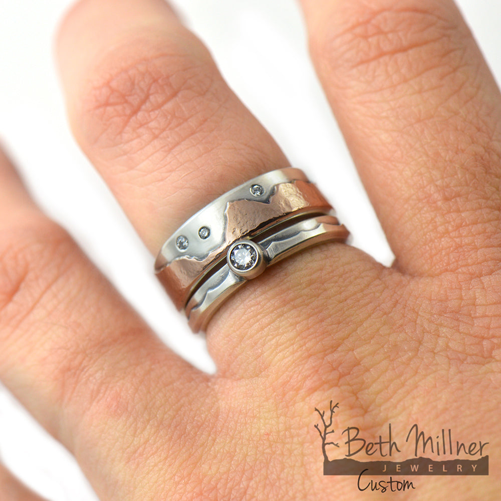 Custom Sterling Silver and Rose Gold Mountain Range Ring with flush set diamonds and a matching wave engagement ring in sterling silver with a recycled diamond. Handmade in Marquette, Michigan.