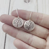 Round Upper Michigan Copper earrings featuring hand sawn trees and stamped leaves. By Beth Millner Jewelry. 