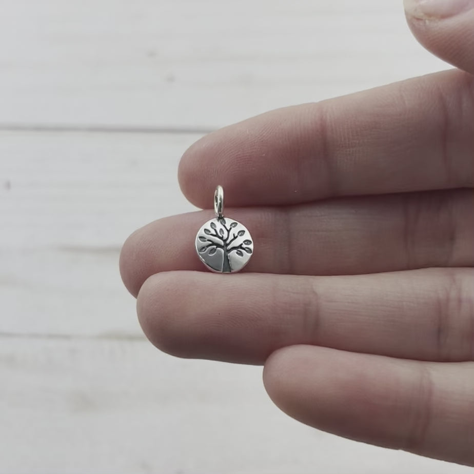 Tiny summer tree lentil charm, made from recycled sterling silver. Hand crafted in Marquette Michigan by Beth Millner jewelry using sustainable materials and practices.