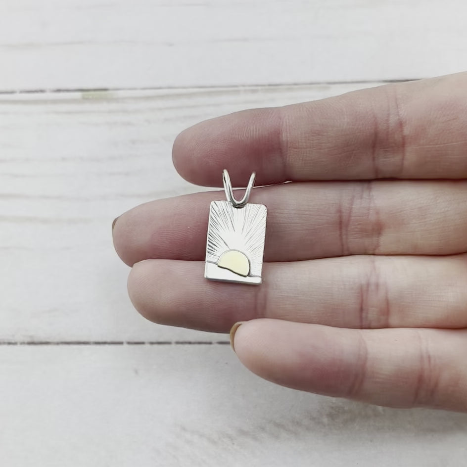 Rectangle sterling silver pendant with a brass sun. Handmade by Beth Millner Jewelry