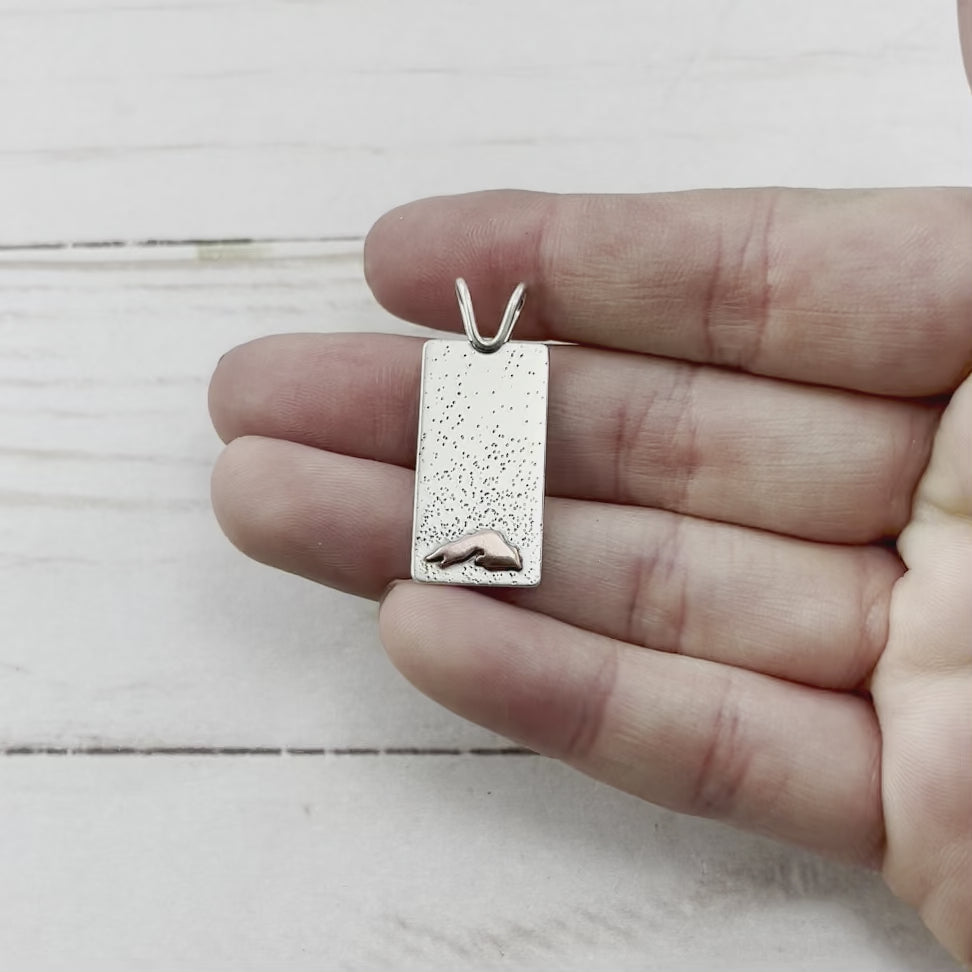 Rectangle sterling silver pendant with a copper Lake Superior. Handmade by Beth Millner Jewelry.