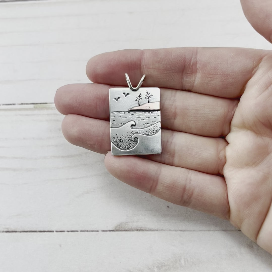 Rectangle sterling silver mixed metal pendant with hand sawn trees, a copper landscape and waves. Handmade by Beth Millner Jewelry